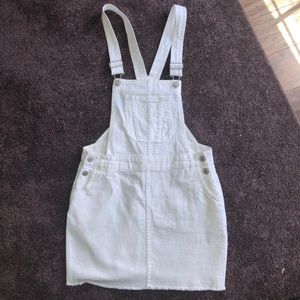 Medium/small white overall denim skirt.